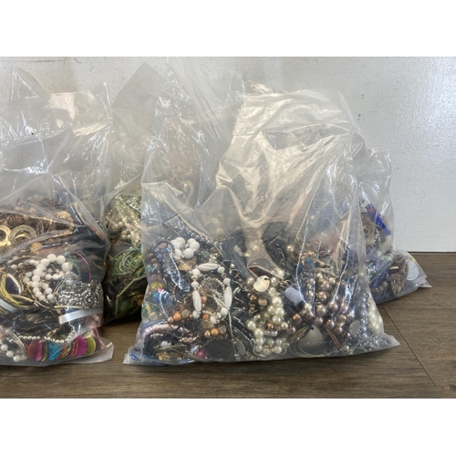 393 - Five bags containing costume jewellery