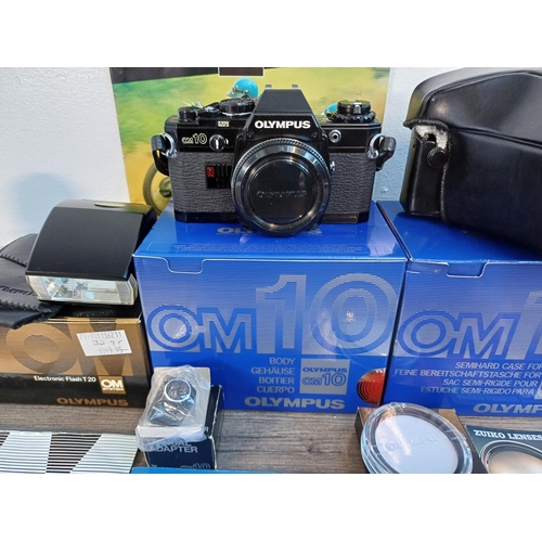 58 - Six boxed Olympus OM system items, one black OM10 35mm SLR body, one Zuiko MC Auto-S 1:1.8 f=50mm le... 