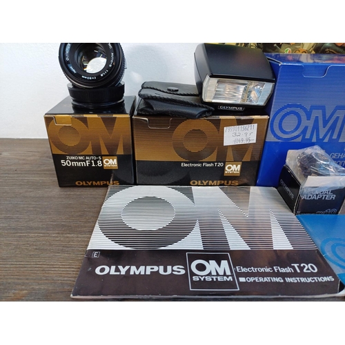 58 - Six boxed Olympus OM system items, one black OM10 35mm SLR body, one Zuiko MC Auto-S 1:1.8 f=50mm le... 