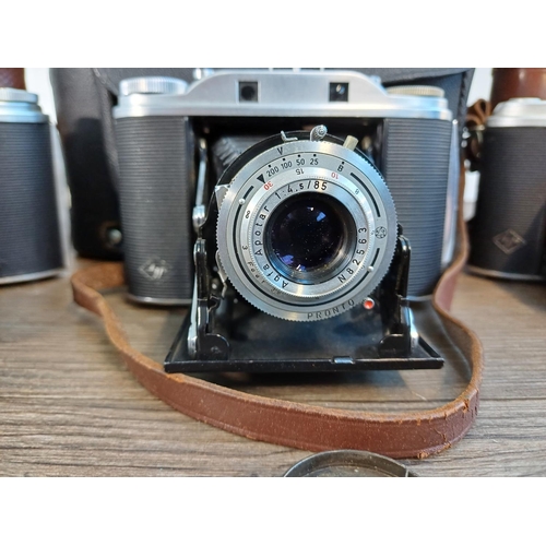 61 - A camera case containing 1950s Agfa Isolette III uncoupled rangefinder folding camera for 6x6 images... 