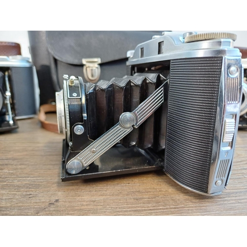 61 - A camera case containing 1950s Agfa Isolette III uncoupled rangefinder folding camera for 6x6 images... 