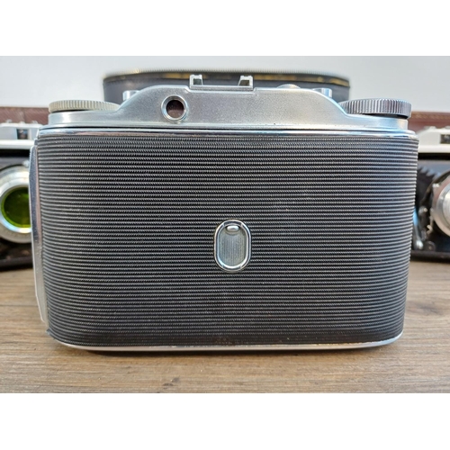 61 - A camera case containing 1950s Agfa Isolette III uncoupled rangefinder folding camera for 6x6 images... 