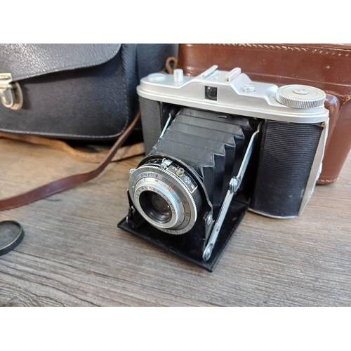 61 - A camera case containing 1950s Agfa Isolette III uncoupled rangefinder folding camera for 6x6 images... 