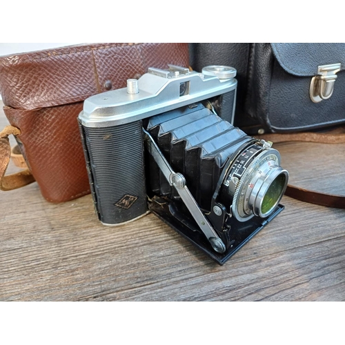 61 - A camera case containing 1950s Agfa Isolette III uncoupled rangefinder folding camera for 6x6 images... 