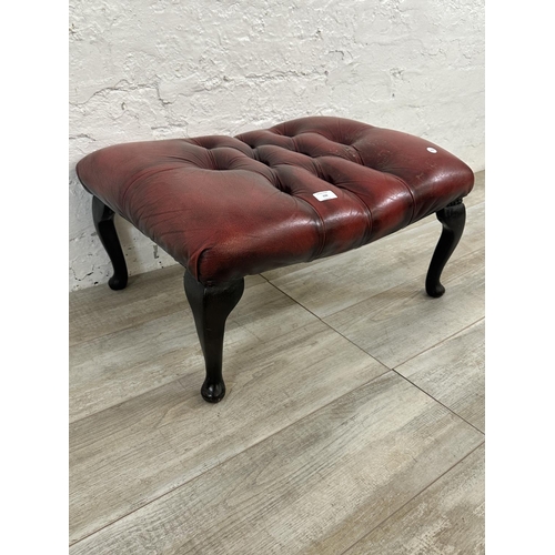 150 - An oxblood leather Chesterfield footstool on cabriole supports - approx. 32cm high x 64cm wide x 49c... 