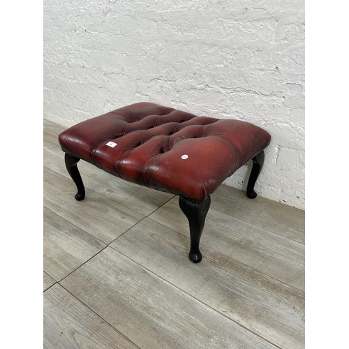 150 - An oxblood leather Chesterfield footstool on cabriole supports - approx. 32cm high x 64cm wide x 49c... 