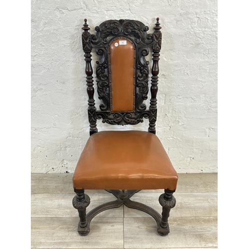 153 - A 19th century carved oak and tan vinyl upholstered dining chair