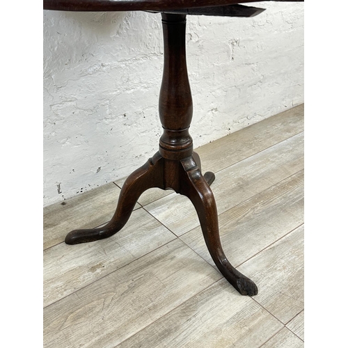 156 - A George III oak circular tilt top tripod pedestal occasional table - approx. 70cm high x 74cm diame... 