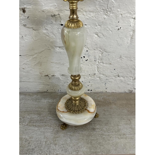 16 - Four onyx and gilt metal items, three candelabras and one floor standing ashtray - approx. 64cm high