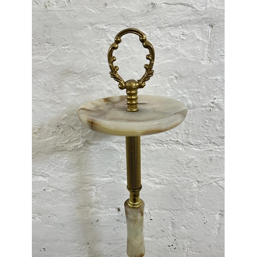 16 - Four onyx and gilt metal items, three candelabras and one floor standing ashtray - approx. 64cm high