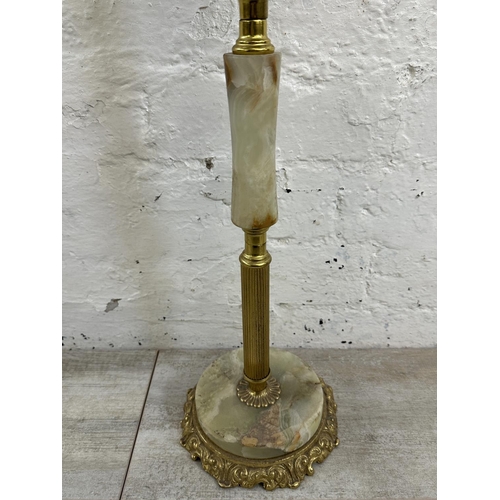 16 - Four onyx and gilt metal items, three candelabras and one floor standing ashtray - approx. 64cm high