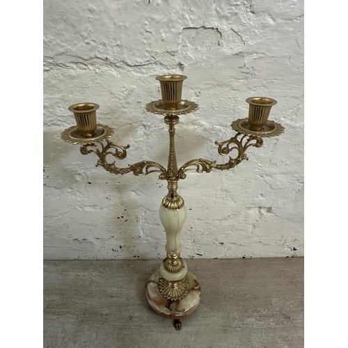 16 - Four onyx and gilt metal items, three candelabras and one floor standing ashtray - approx. 64cm high