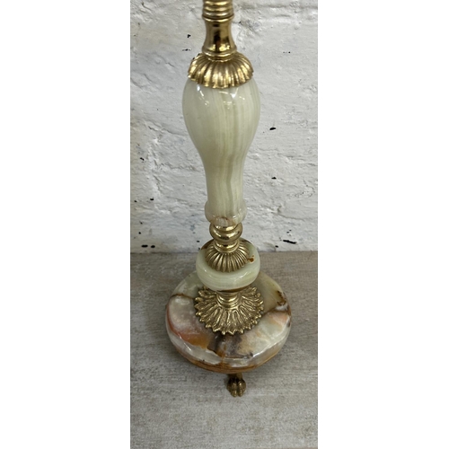 16 - Four onyx and gilt metal items, three candelabras and one floor standing ashtray - approx. 64cm high