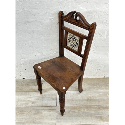 160 - A 19th century oak hall chair with ceramic tile insert