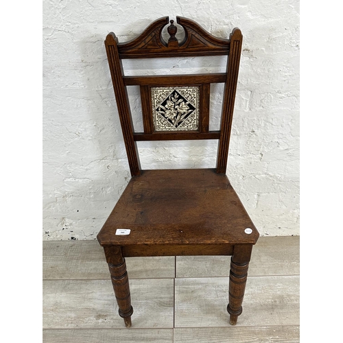 160 - A 19th century oak hall chair with ceramic tile insert