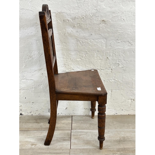 160 - A 19th century oak hall chair with ceramic tile insert