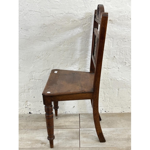 160 - A 19th century oak hall chair with ceramic tile insert