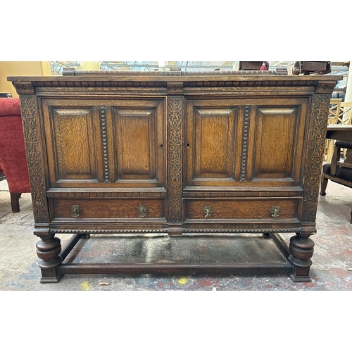 161 - An early 20th century carved oak sideboard - approx. 107cm high x 137cm wide x 53cm deep