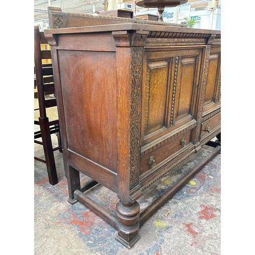 161 - An early 20th century carved oak sideboard - approx. 107cm high x 137cm wide x 53cm deep