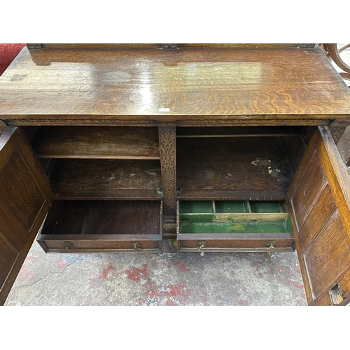 161 - An early 20th century carved oak sideboard - approx. 107cm high x 137cm wide x 53cm deep