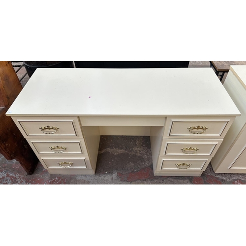 163A - A white laminate bedroom suite comprising pair of bedside chests of drawers, dressing table with sto... 