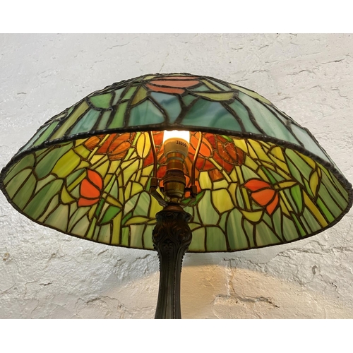 168 - A Tiffany style stained glass and bronzed cast metal table lamp - approx. 64cm high