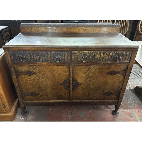 169 - An early 20th century carved oak sideboard - approx. 104cm high x 122cm wide x 47cm deep