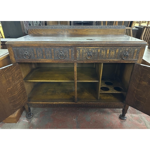 169 - An early 20th century carved oak sideboard - approx. 104cm high x 122cm wide x 47cm deep