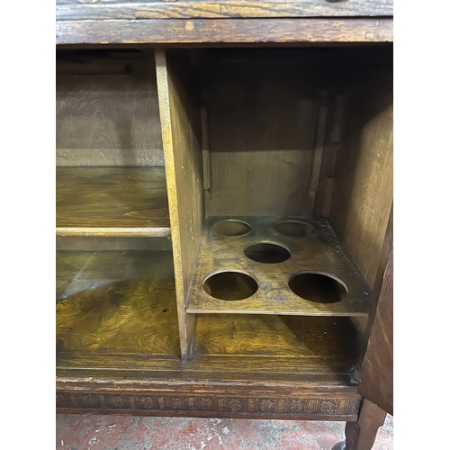 169 - An early 20th century carved oak sideboard - approx. 104cm high x 122cm wide x 47cm deep