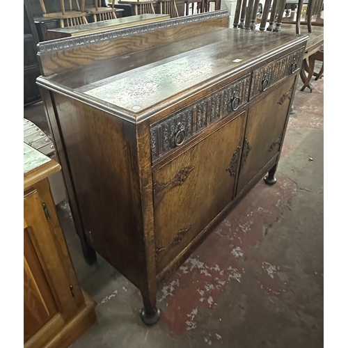 169 - An early 20th century carved oak sideboard - approx. 104cm high x 122cm wide x 47cm deep