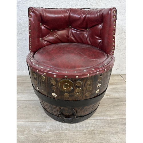 172 - An antique coopered oak and iron banded barrel chair with red vinyl upholstery - approx. 66cm high x... 