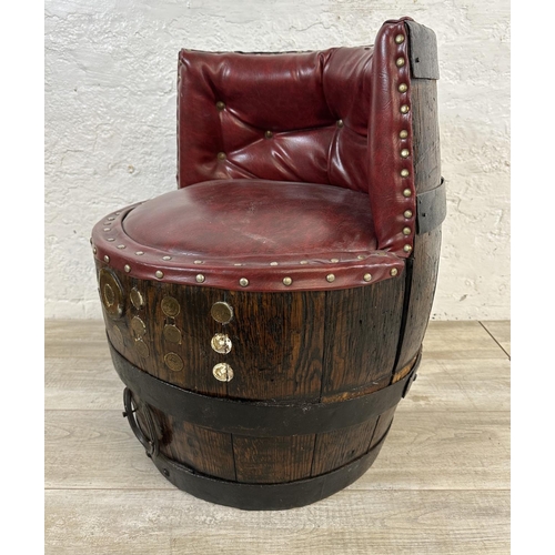 172 - An antique coopered oak and iron banded barrel chair with red vinyl upholstery - approx. 66cm high x... 