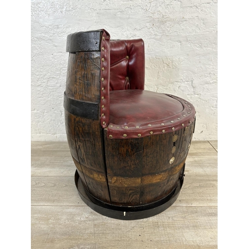 172 - An antique coopered oak and iron banded barrel chair with red vinyl upholstery - approx. 66cm high x... 