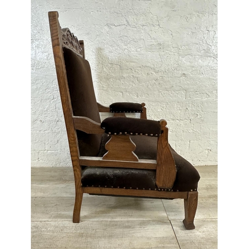 174 - A late Victorian/Edwardian carved oak and brown fabric upholstered parlour chair