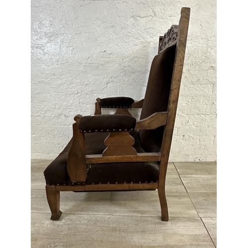 174 - A late Victorian/Edwardian carved oak and brown fabric upholstered parlour chair