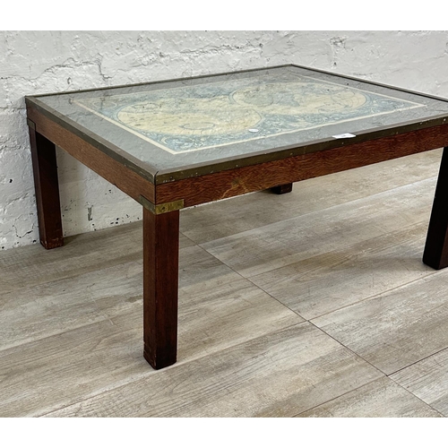 178 - A mid 20th century mahogany and brass banded coffee table with glass top and printed map design - ap... 