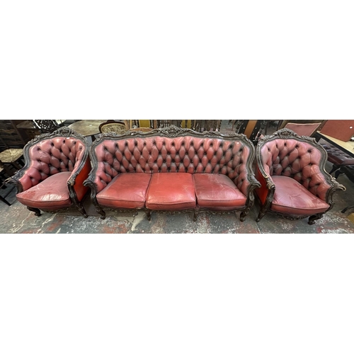 181 - A French Louis XV style carved beech and red leather three piece parlour suite comprising three seat... 