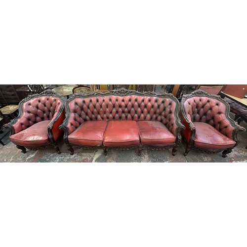 181 - A French Louis XV style carved beech and red leather three piece parlour suite comprising three seat... 