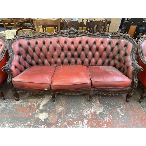 181 - A French Louis XV style carved beech and red leather three piece parlour suite comprising three seat... 