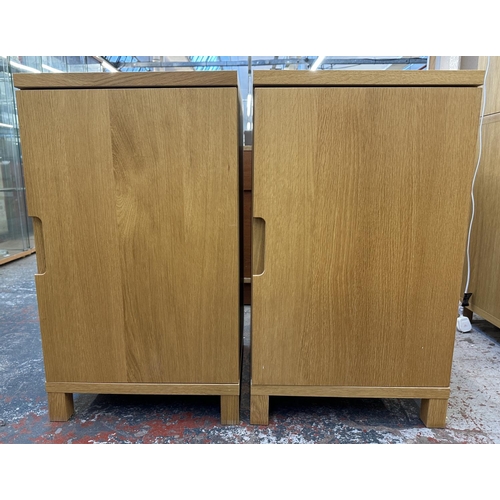 183 - A pair of modern oak effect single door cabinets - approx. 74cm high x 43cm wide x 42cm deep