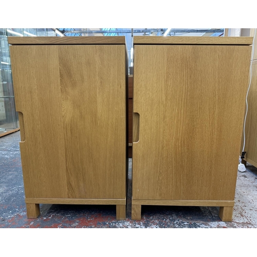 183 - A pair of modern oak effect single door cabinets - approx. 74cm high x 43cm wide x 42cm deep