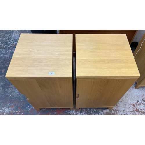 183 - A pair of modern oak effect single door cabinets - approx. 74cm high x 43cm wide x 42cm deep