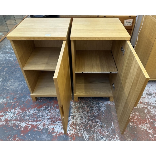 183 - A pair of modern oak effect single door cabinets - approx. 74cm high x 43cm wide x 42cm deep