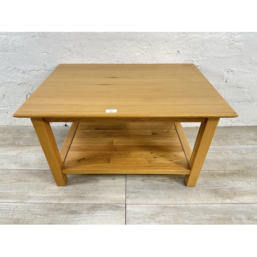 186 - A modern oak rectangular two tier coffee table - approx. 45cm high x 53cm wide x 76cm long