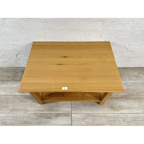 186 - A modern oak rectangular two tier coffee table - approx. 45cm high x 53cm wide x 76cm long