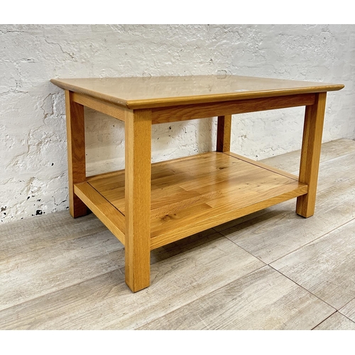 186 - A modern oak rectangular two tier coffee table - approx. 45cm high x 53cm wide x 76cm long