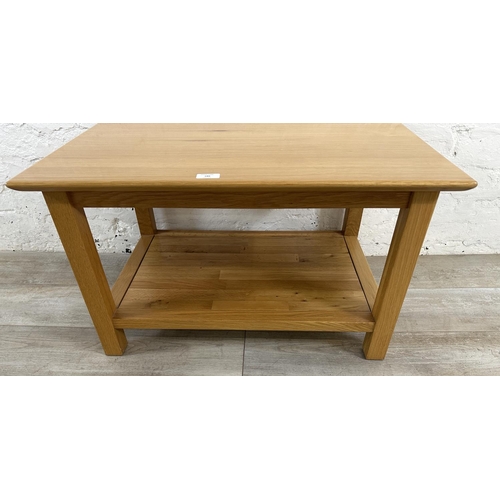 186 - A modern oak rectangular two tier coffee table - approx. 45cm high x 53cm wide x 76cm long