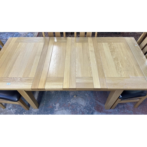 188 - A modern solid oak extending dining table and eight chairs - approx. 78cm high x 91cm wide x 199cm l... 