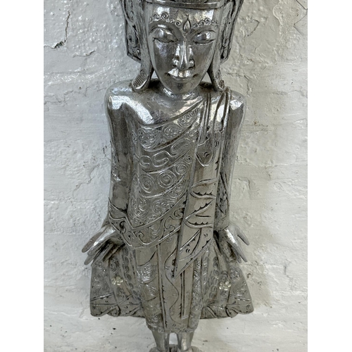 19 - A Thai silver painted carved hardwood buddha statue - approx. 116cm high