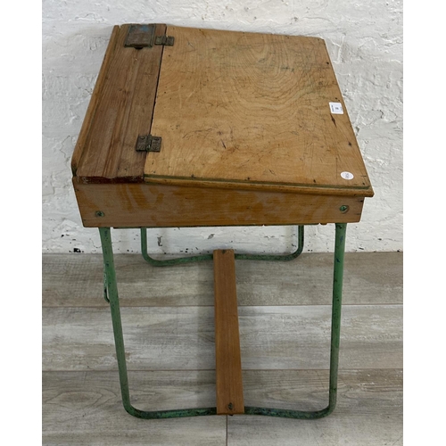 22 - A mid 20th century beech and plywood child's school desk on green painted tubular metal stand - appr... 